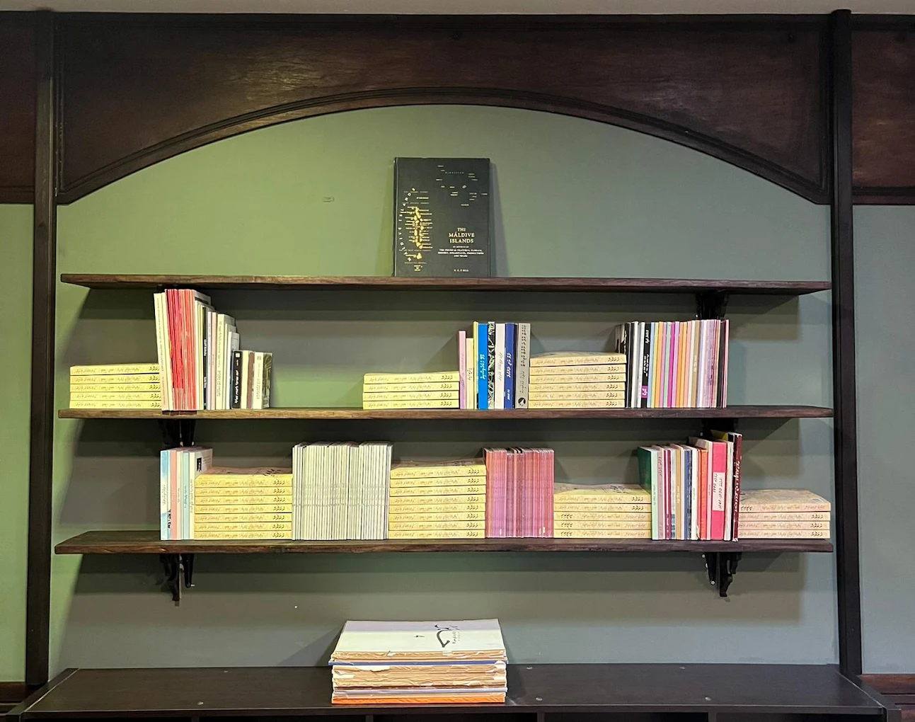 People flipping through zines at a cozy wooden table.