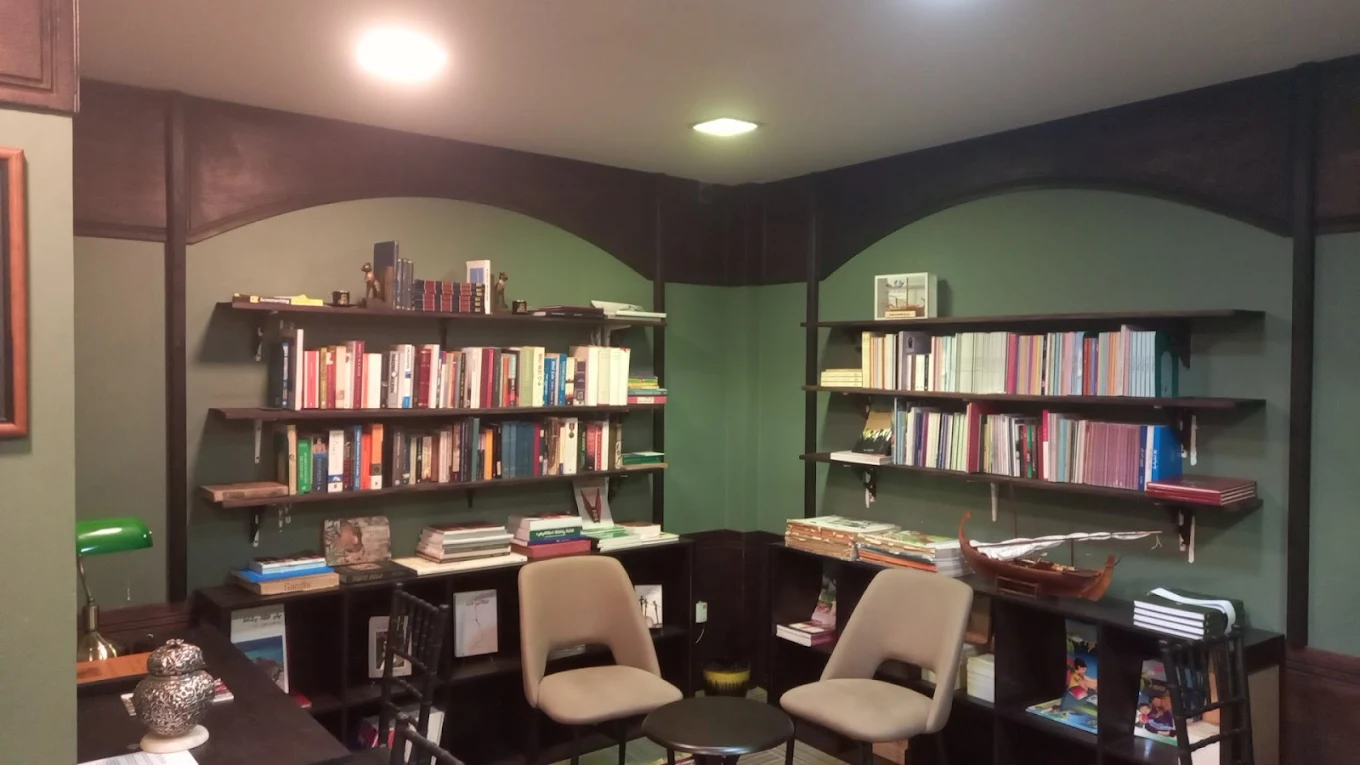 Aerial view of a latte and sketchbook on a wooden desk.